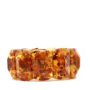 Honey Baltic amber bracelet with broad polished geometric beads, golden-yellow tones and visible reddish-brown inclusions.