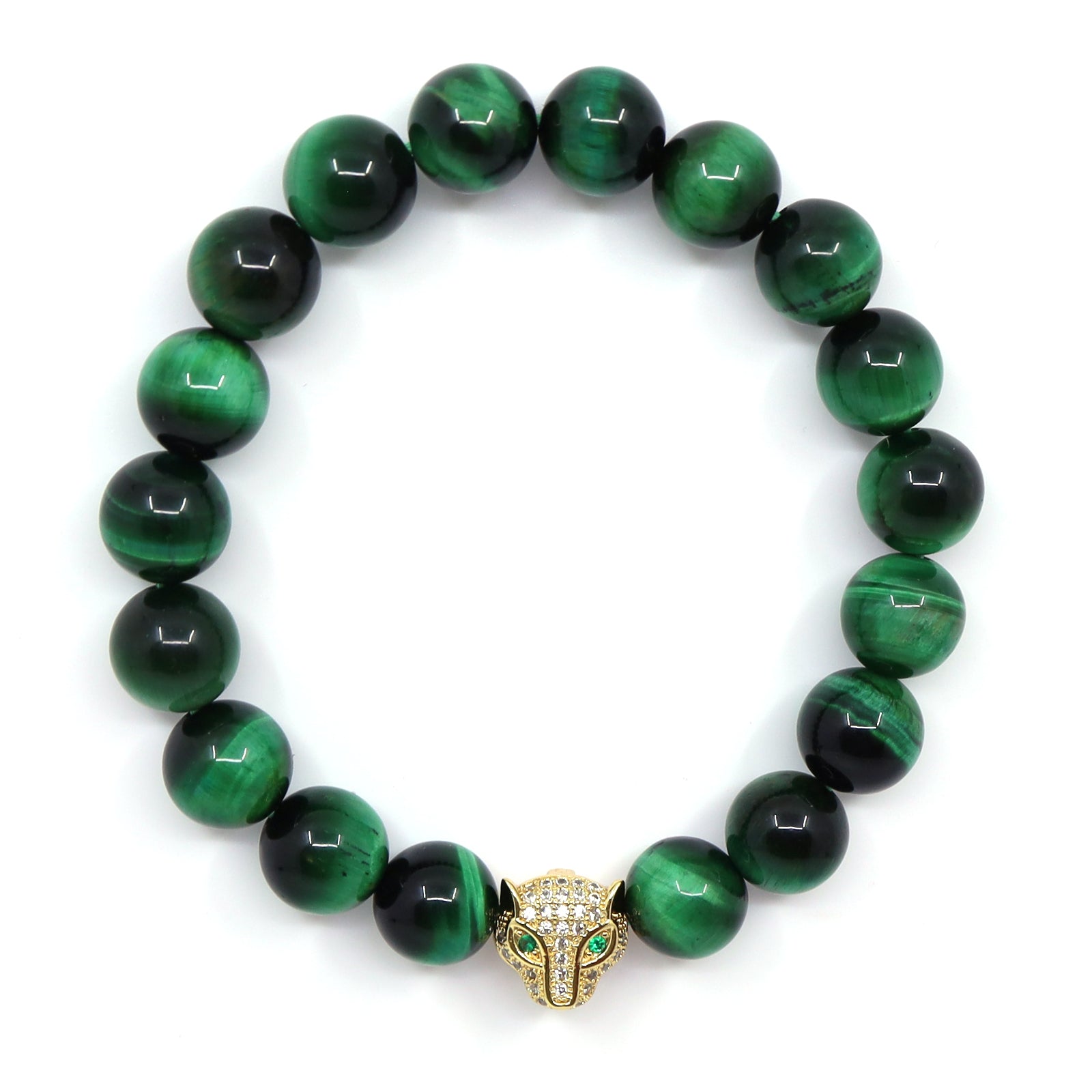 Overhead view of a green tiger's eye bracelet with round banded beads and a gold-plated jaguar head with green eyes.