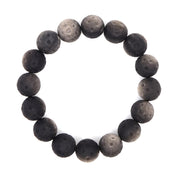 Overhead view of the silver obsidian bracelet, showing the full circle of textured dark grey beads with lighter silver-grey patches.